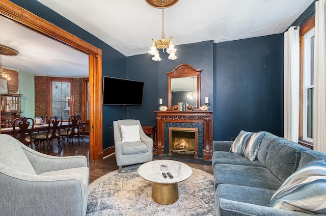 346 W 9th St W, Covington, KY 41011 - living area with a chandelier, wood finished floors, a glass covered fireplace, and baseboards