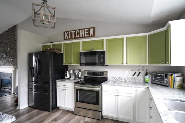 kitchen featuring black appliances, green cabinets, vaulted ceiling, wood finished floors, and light stone countertops