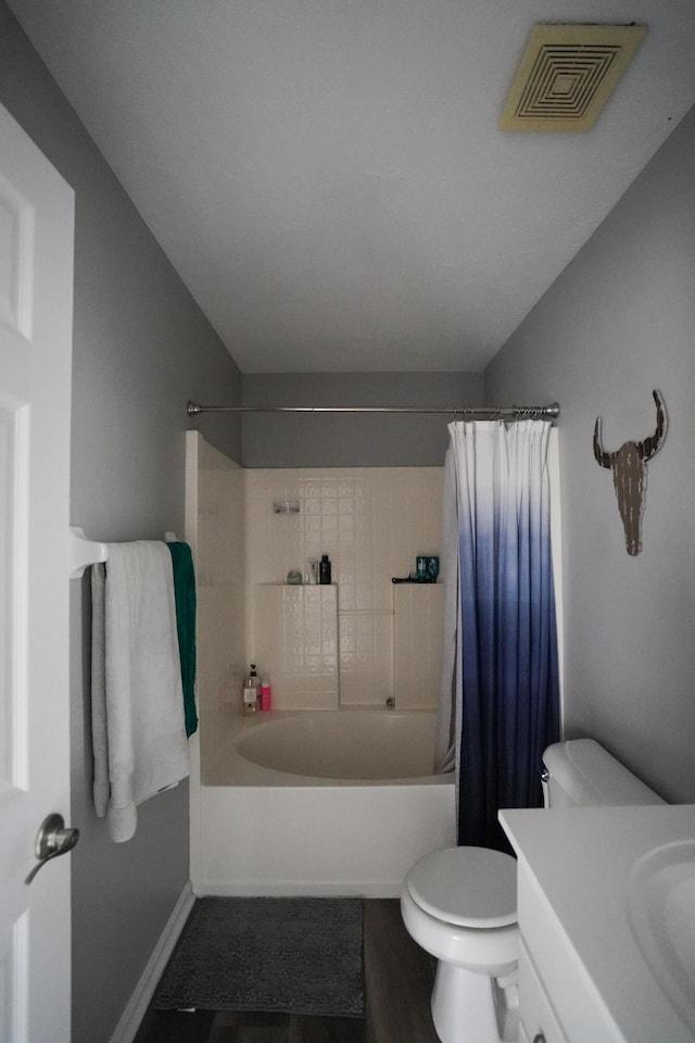full bathroom with toilet, wood finished floors, vanity, and shower / bathtub combination with curtain
