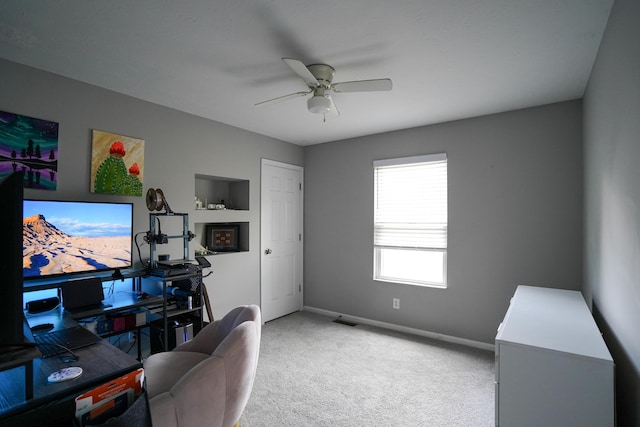 office area with a ceiling fan, carpet floors, and baseboards