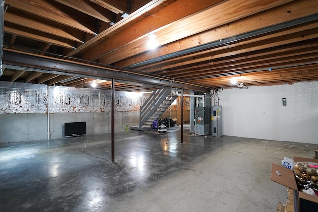 unfinished basement featuring water heater, stairway, and heating unit