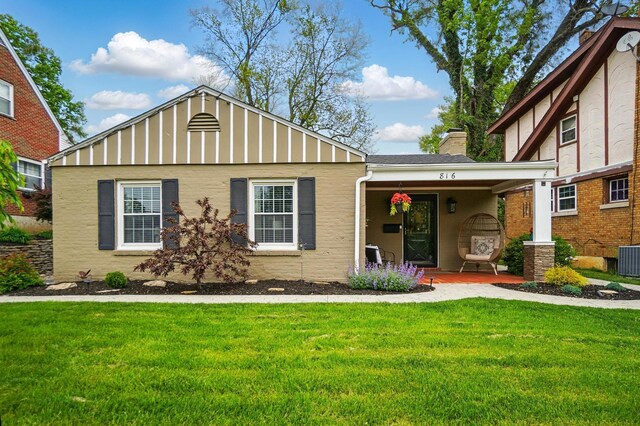 816 Aberdeen Rd, Covington, KY 41011 - view of front of property featuring a front lawn, covered porch, a chimney, stucco siding, and cooling unit