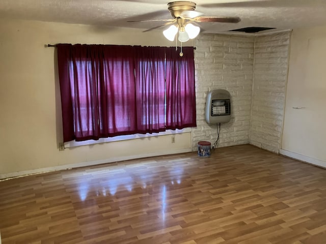 4910 Fowler Creek Rd, Covington, KY 41017 - empty room featuring heating unit, a ceiling fan, wood finished floors, baseboards, and a textured ceiling