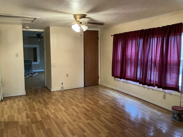 4910 Fowler Creek Rd, Covington, KY 41017 - spare room featuring ceiling fan, a textured ceiling, attic access, wood finished floors, and baseboards