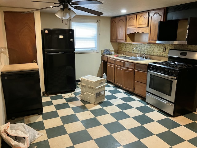 4910 Fowler Creek Rd, Covington, KY 41017 - kitchen featuring freestanding refrigerator, stainless steel gas range oven, ceiling fan, a sink, and light floors