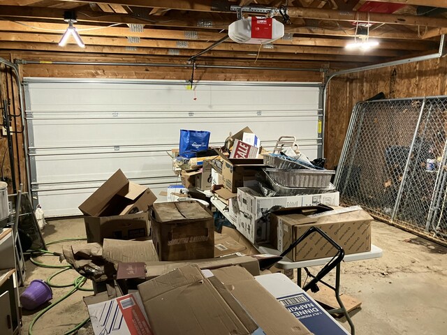 4910 Fowler Creek Rd, Covington, KY 41017 - garage featuring a garage door opener and wooden walls