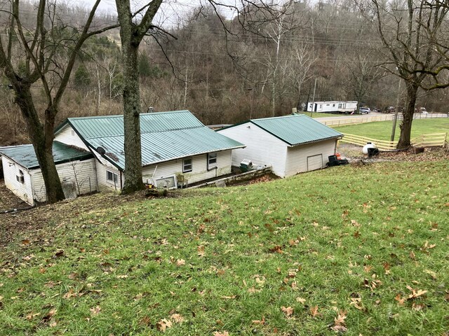 4910 Fowler Creek Rd, Covington, KY 41017 - view of property exterior with metal roof and a lawn