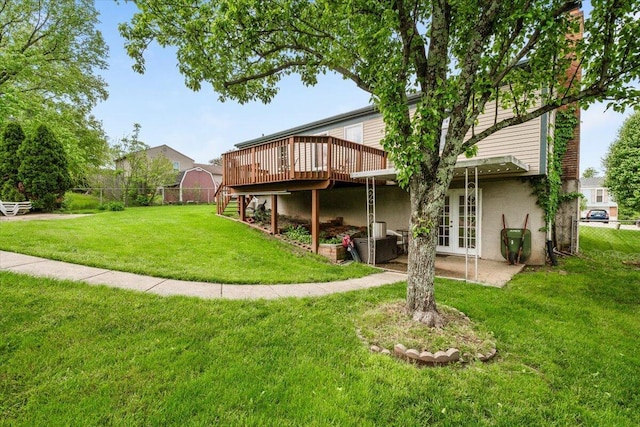 rear view of property with french doors, a wooden deck, and stucco siding