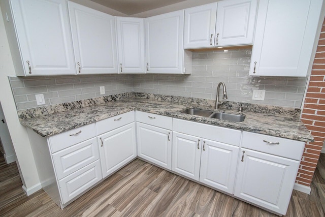 516 Buckner St, Elsmere, KY 41018 - kitchen with a sink, light wood-style flooring, backsplash, and white cabinetry