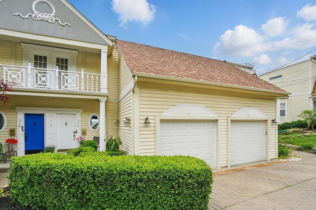 516 Western Ave, Covington, KY 41011 - view of front of house with a balcony, decorative driveway, and roof with shingles