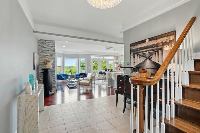 516 Western Ave, Covington, KY 41011 - staircase with tile patterned floors, a stone fireplace, a chandelier, and recessed lighting