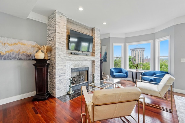 516 Western Ave, Covington, KY 41011 - living room featuring baseboards, hardwood / wood-style flooring, a stone fireplace, and recessed lighting