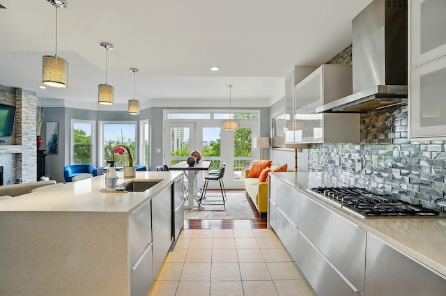 516 Western Ave, Covington, KY 41011 - kitchen with a sink, wall chimney range hood, stainless steel gas cooktop, backsplash, and plenty of natural light