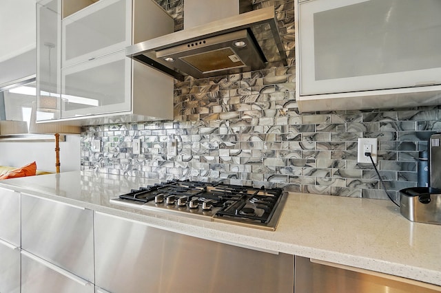 516 Western Ave, Covington, KY 41011 - kitchen with ventilation hood, stainless steel gas stovetop, decorative backsplash, light stone counters, and white cabinetry