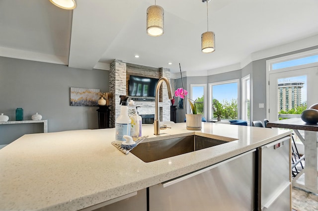 516 Western Ave, Covington, KY 41011 - kitchen featuring a sink, light stone countertops, hanging light fixtures, stainless steel dishwasher, and open floor plan