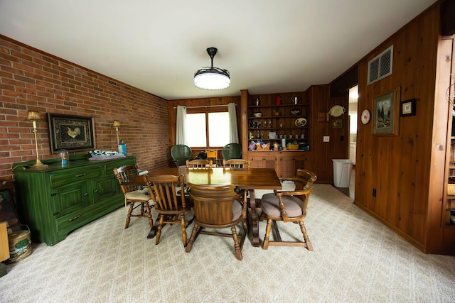 dining area with wood walls and brick wall