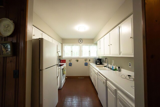 kitchen featuring white appliances, a sink, light countertops, and white cabinetry