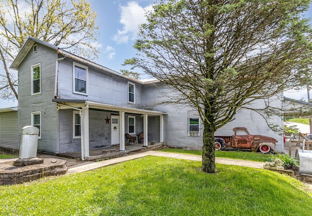 7595 Willow Lenoxburg Rd, Foster, KY 41043 - view of front facade with brick siding, a front yard, and covered porch