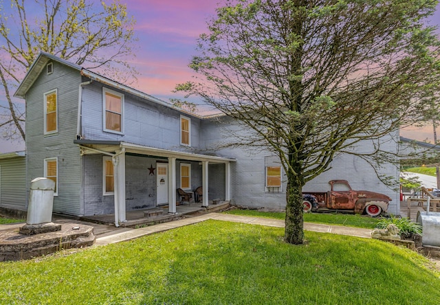 7595 Willow Lenoxburg Rd, Foster, KY 41043 - view of front facade featuring brick siding, covered porch, and a lawn