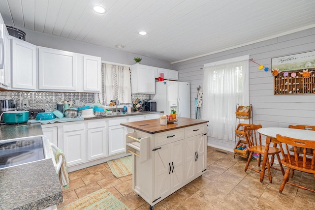7595 Willow Lenoxburg Rd, Foster, KY 41043 - kitchen featuring white appliances, wood counters, white cabinets, wooden walls, and recessed lighting