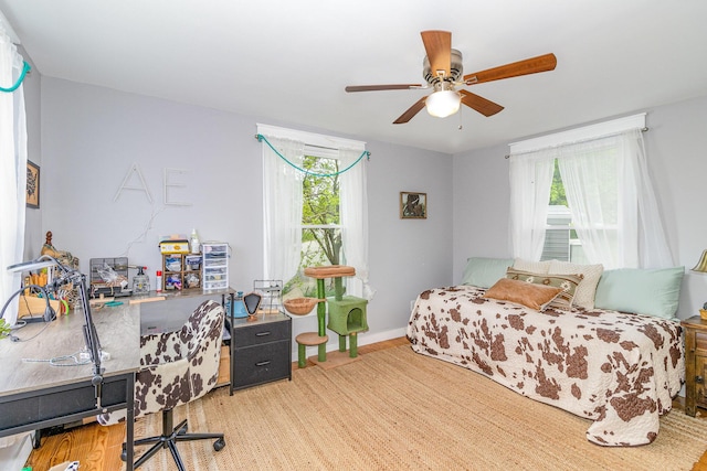 7595 Willow Lenoxburg Rd, Foster, KY 41043 - bedroom featuring multiple windows, wood finished floors, a desk, and ceiling fan