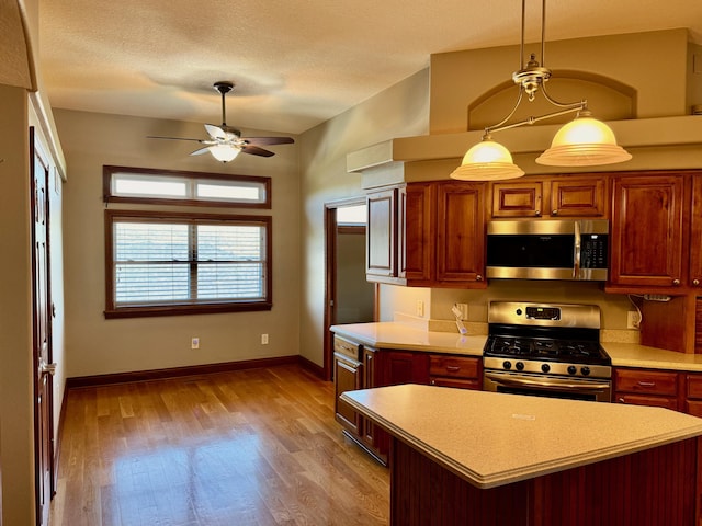 410 Links View Dr, Butler, KY 41006 - kitchen with stainless steel appliances, light countertops, ceiling fan, and light wood finished floors
