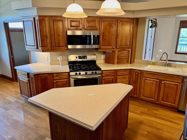 410 Links View Dr, Butler, KY 41006 - kitchen with stainless steel appliances, a sink, brown cabinetry, and light countertops