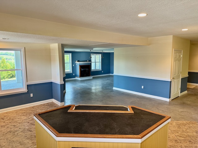 410 Links View Dr, Butler, KY 41006 - unfurnished room featuring a textured ceiling, baseboards, a fireplace with raised hearth, and recessed lighting
