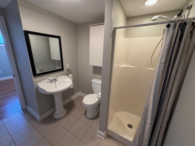 410 Links View Dr, Butler, KY 41006 - bathroom with a shower stall, toilet, tile patterned flooring, and baseboards