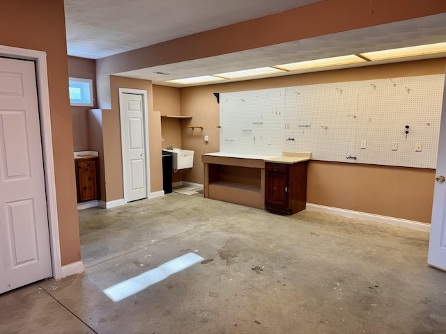 410 Links View Dr, Butler, KY 41006 - unfurnished office featuring a workshop area, unfinished concrete flooring, a sink, and baseboards