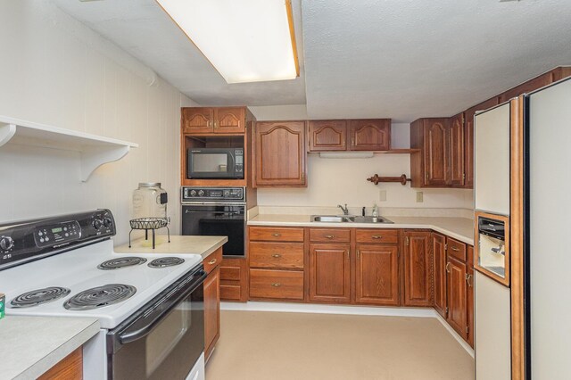 1051 Arden Dr, Villa Hills, KY 41017 - kitchen featuring black appliances, a sink, light countertops, and brown cabinetry