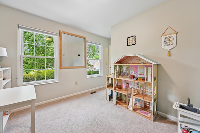 playroom featuring carpet floors and baseboards