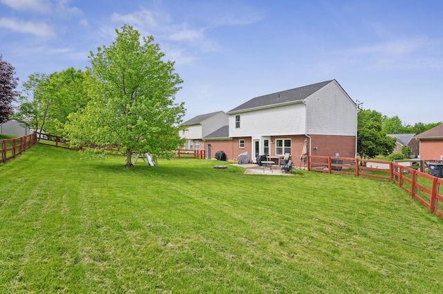 back of house with brick siding and a patio