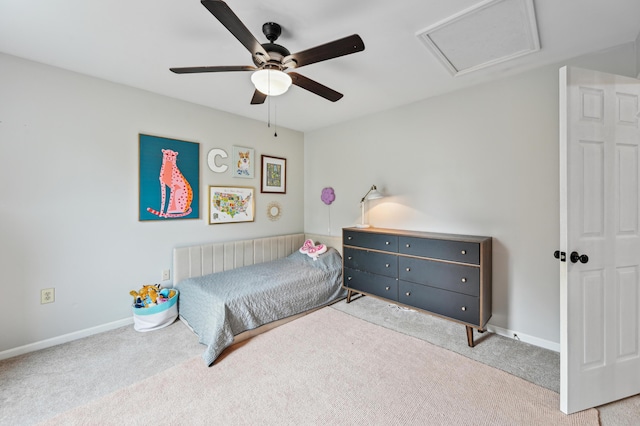bedroom featuring carpet, ceiling fan, baseboards, and attic access