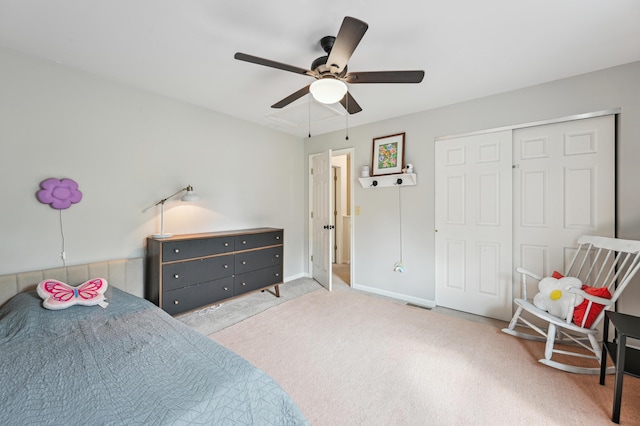 bedroom featuring carpet flooring, ceiling fan, a closet, and baseboards
