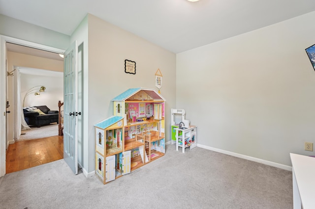 rec room with carpet floors, baseboards, and french doors