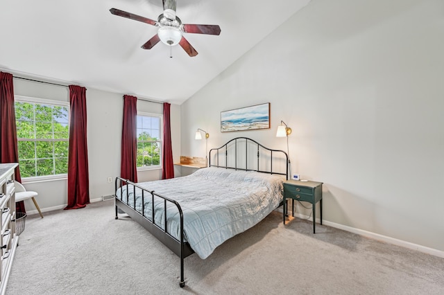 carpeted bedroom with vaulted ceiling, baseboards, and a ceiling fan