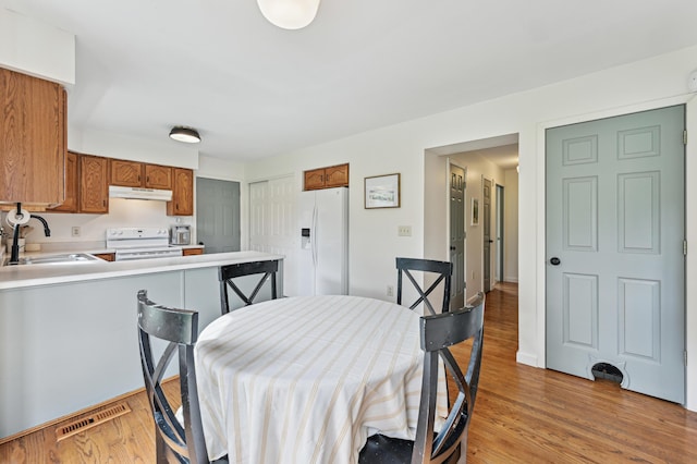 dining room with light wood-style flooring