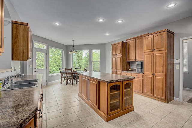 2282 Treetop Ln, Hebron, KY 41048 - kitchen with baseboards, brown cabinetry, a sink, recessed lighting, and glass insert cabinets