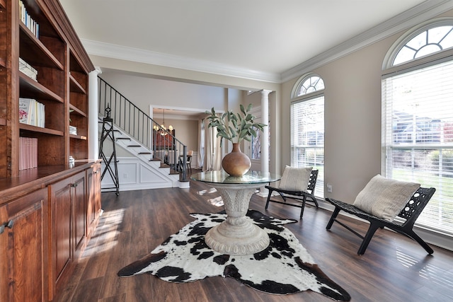 foyer with crown molding, stairway, dark wood-type flooring, and decorative columns