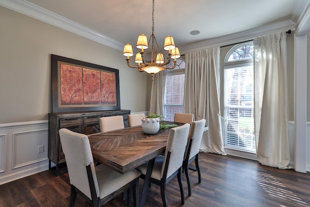 dining area with a chandelier, ornamental molding, dark wood-style flooring, and wainscoting