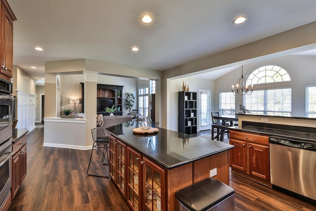 kitchen featuring stainless steel appliances, dark wood finished floors, a kitchen island, a chandelier, and recessed lighting