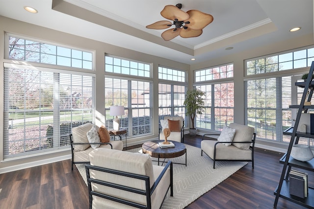 sunroom / solarium with a raised ceiling, healthy amount of natural light, ornamental molding, and recessed lighting