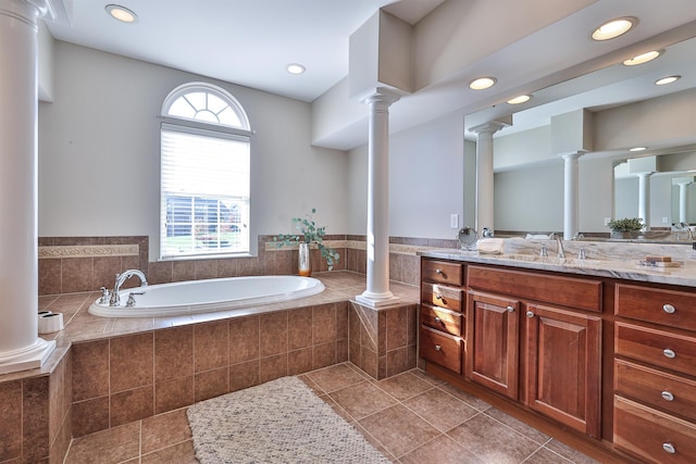 bathroom with ornate columns, vanity, tile patterned flooring, a garden tub, and recessed lighting