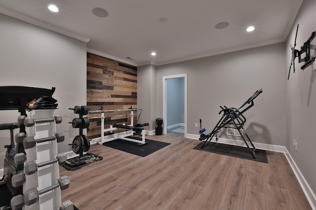 workout area featuring crown molding, recessed lighting, wood finished floors, and baseboards