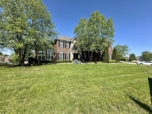 view of front facade featuring a front lawn and brick siding