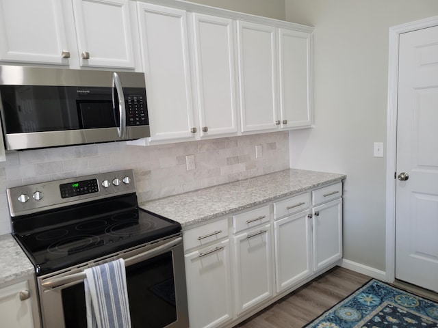 6403 Arabian Dr, Independence, KY 41051 - kitchen featuring appliances with stainless steel finishes, white cabinets, tasteful backsplash, and light stone countertops
