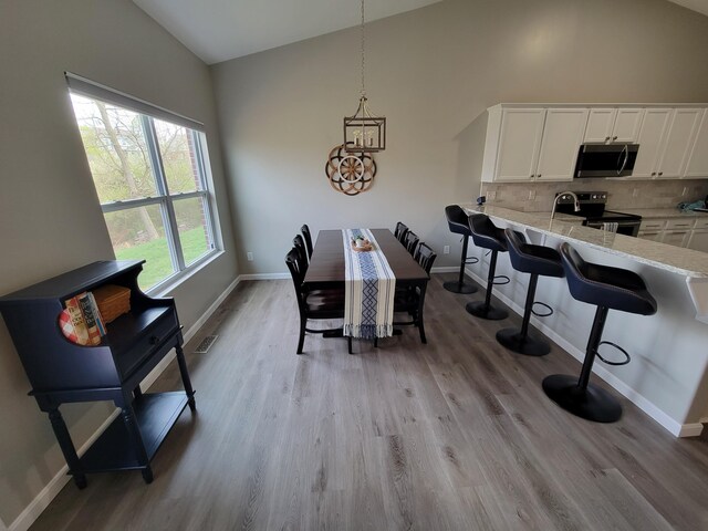 6403 Arabian Dr, Independence, KY 41051 - dining room featuring light wood-style flooring, baseboards, and high vaulted ceiling