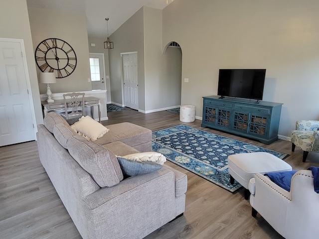 6403 Arabian Dr, Independence, KY 41051 - living room featuring baseboards, wood finished floors, arched walkways, and high vaulted ceiling