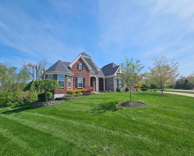 view of front of property featuring a front yard, brick siding, and stone siding